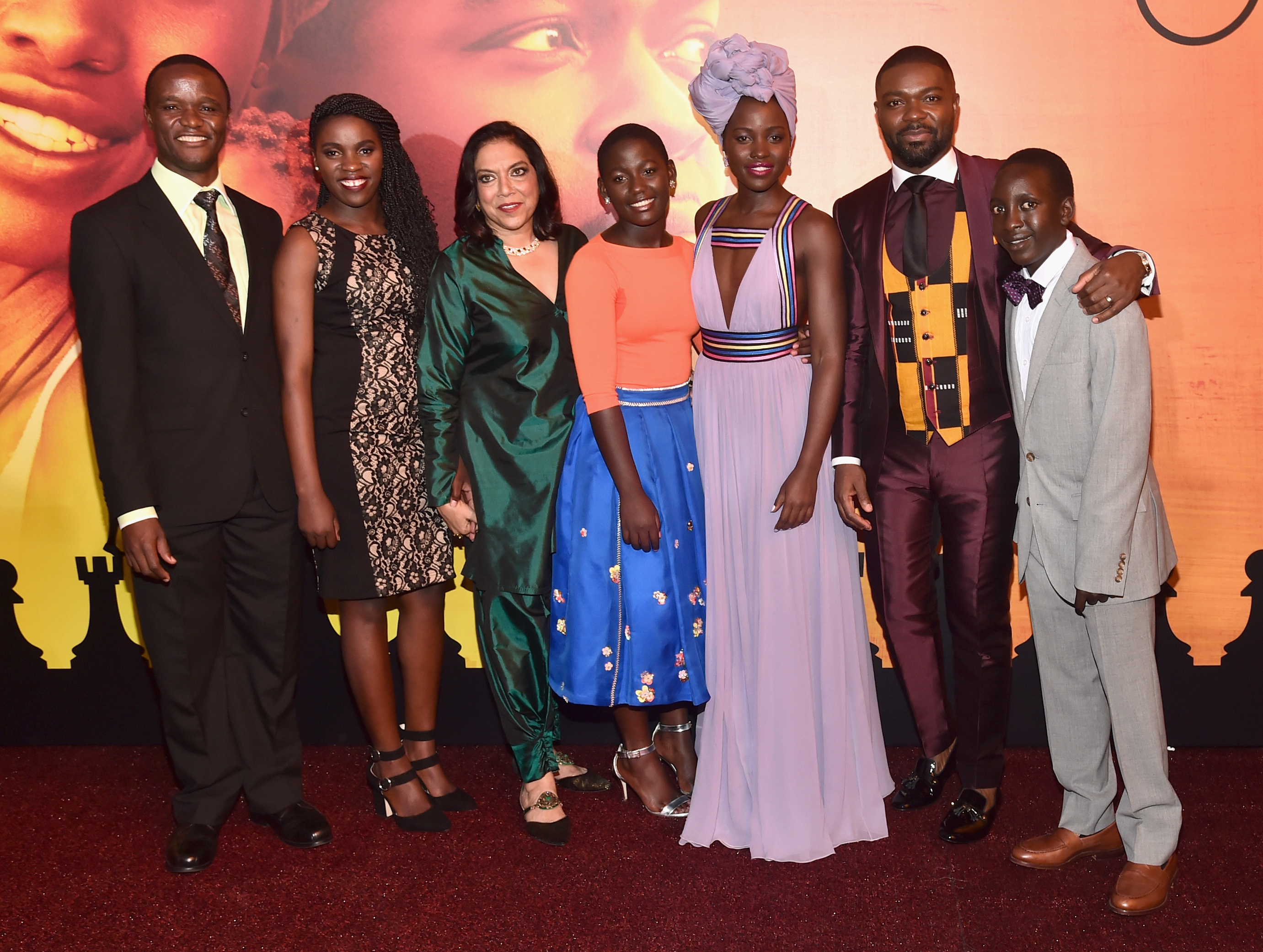 HOLLYWOOD, CA - SEPTEMBER 20: (L-R) Chess Coach and Director of Sports Outreach in Uganda, Robert Katende, Ugandan national chess champion Phiona Mutesi, Director Mira Nair, actors Madina Nalwanga, Lupita Nyong'o, David Oyelowo and Martin Kabanza arrive at the U.S. premiere of Disneys Queen of Katwe at the El Capitan Theatre in Hollywood. The film, starring David Oyelowo, Oscar winner Lupita Nyongo and newcomer Madina Nalwanga, is directed by Mira Nair and opens in U.S. theaters in limited release on September 23, expanding wide September 30, 2016. On September 20, 2016 in Hollywood, California. (Photo by Alberto E. Rodriguez/Getty Images for Disney) *** Local Caption *** Robert Katende; Phiona Mutesi; Mira Nair; Madina Nalwanga; Lupita Nyong'o; David Oyelowo; Martin Kabanza