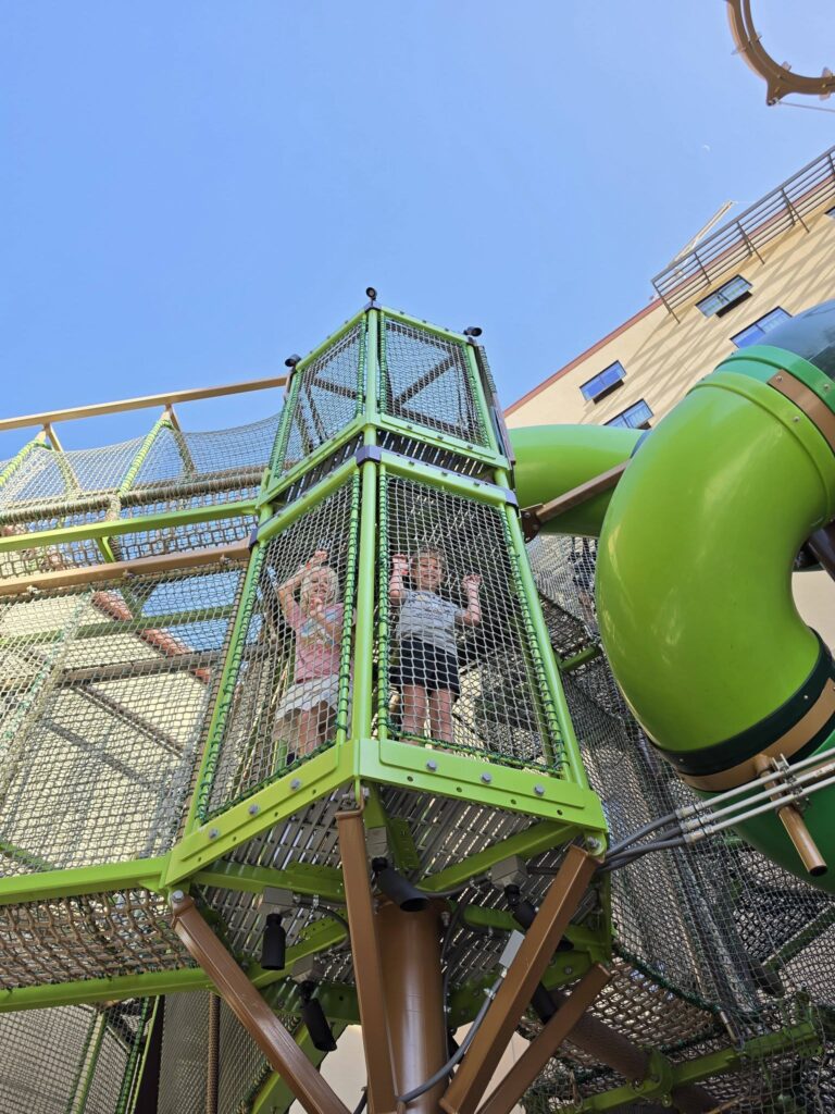 Two kids exploring the Adventure Trail at Great Wolf Lodge using their Wolf Pass.