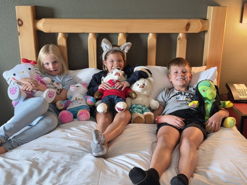 Kids enjoying the keepsakes they made at Build-A-Bear on their Great Wolf Lodge vacation.