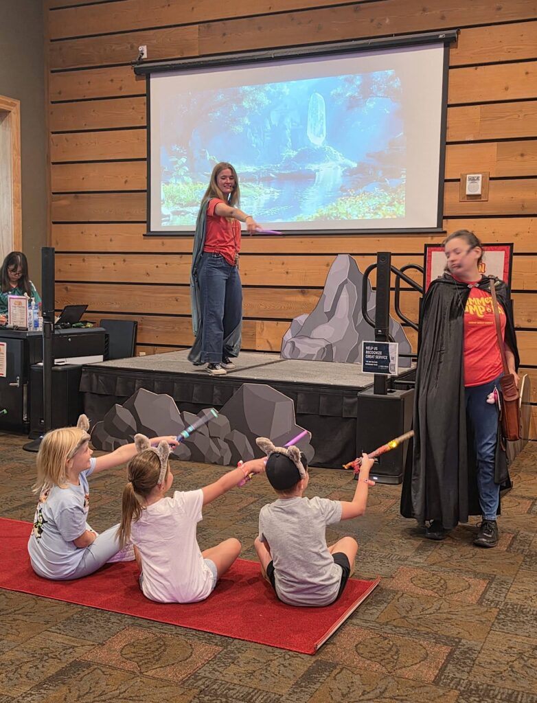 Children participating in the MagiQuest ceremony with magic wands at Great Wolf Lodge.