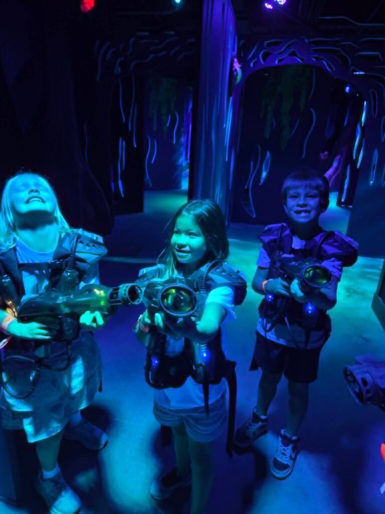 Kids playing laser tag at Great Wolf Lodge during a family vacation.